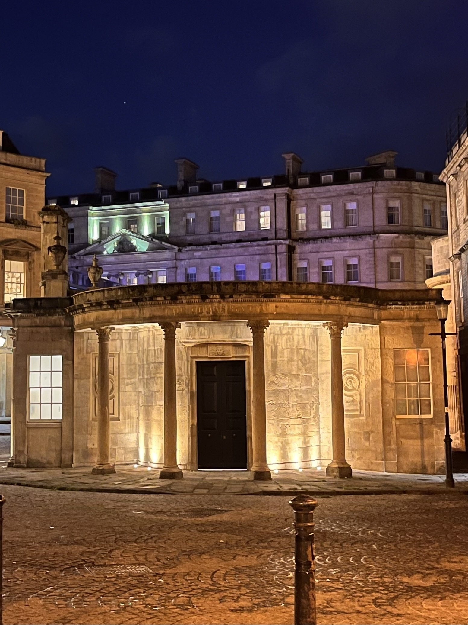 A portico lit up at night in Bath, England