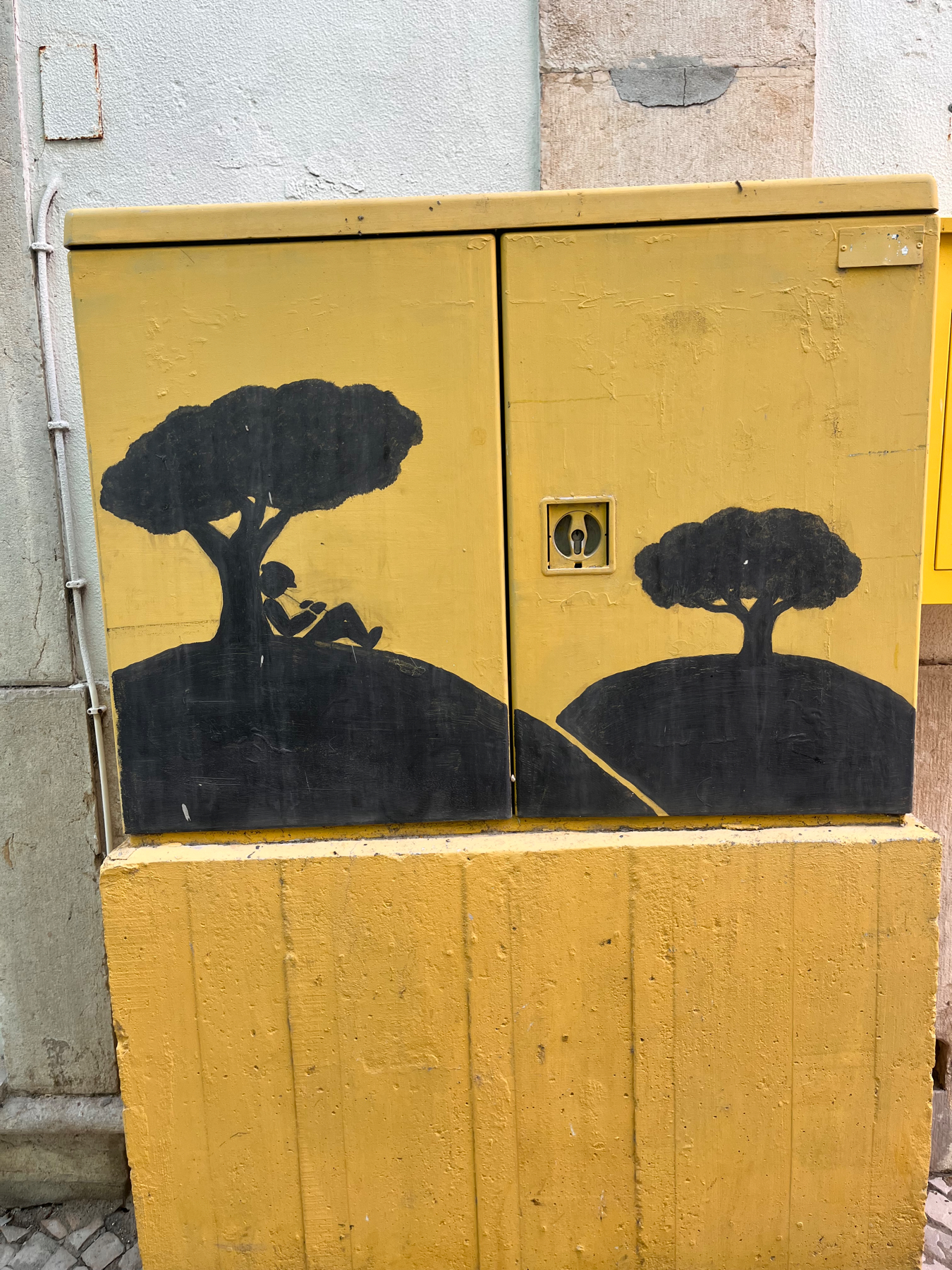 Drawing on an outside cabinet of a man sleeping under a tree