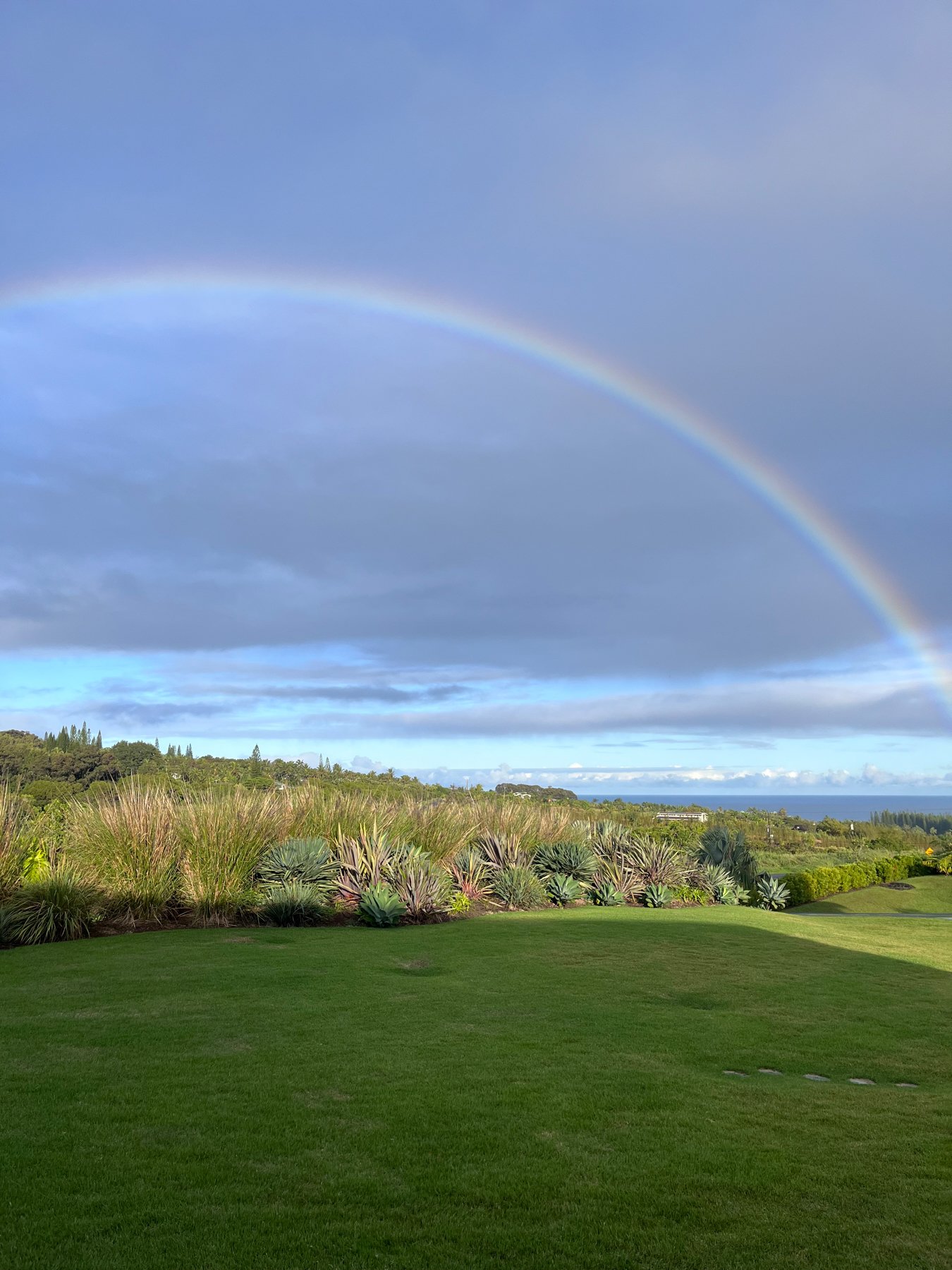 Early morning rainbow over Maui, the Pacific Ocean in the background 