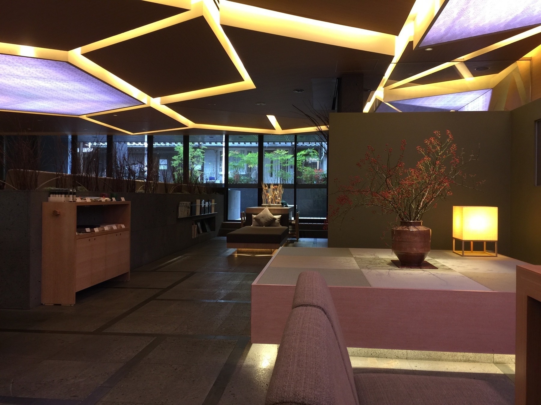 A hotel lobby somewhere in Kyoto with yellow neon lights built into the ceiling
