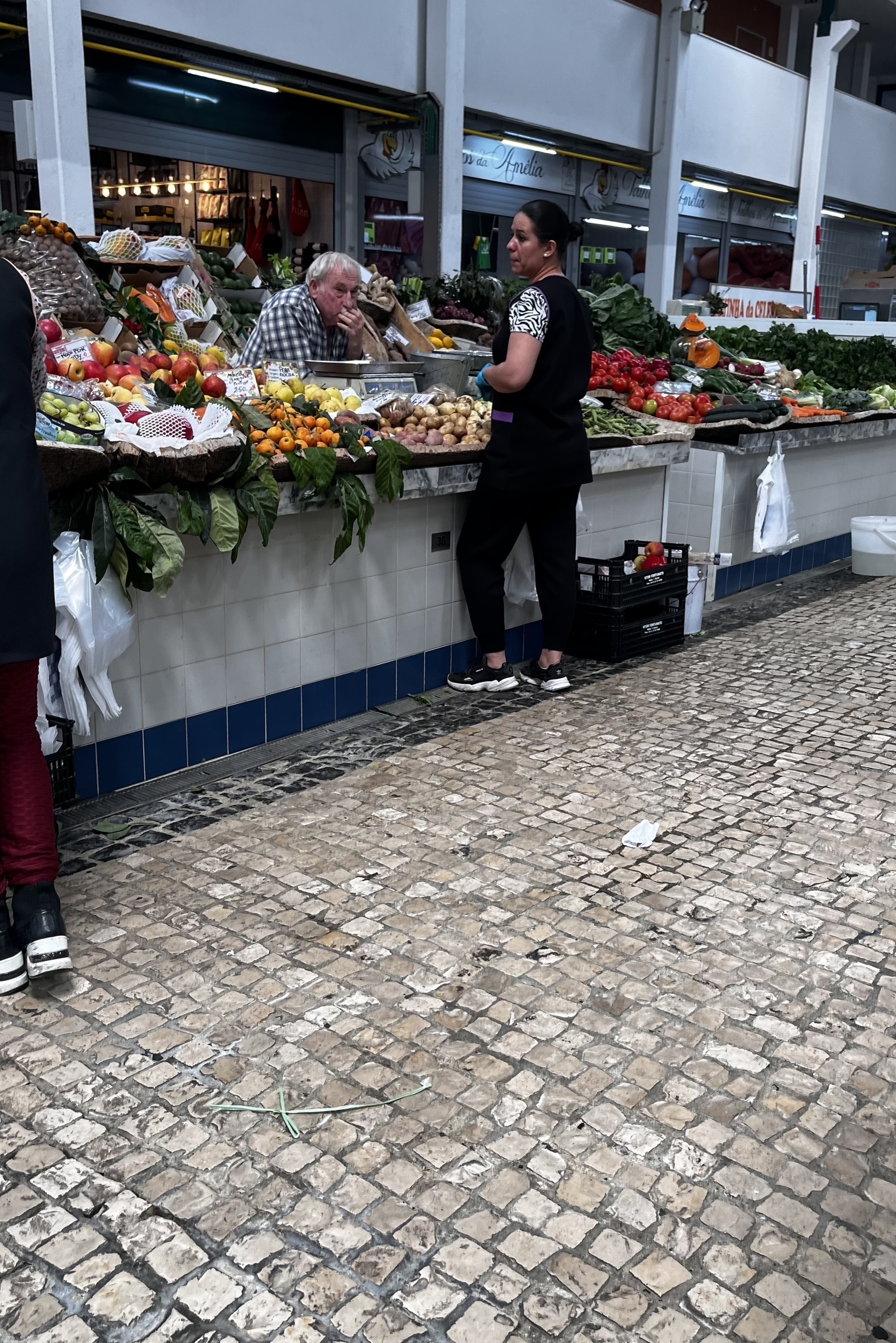 People at vegetable counter in Setúbal market