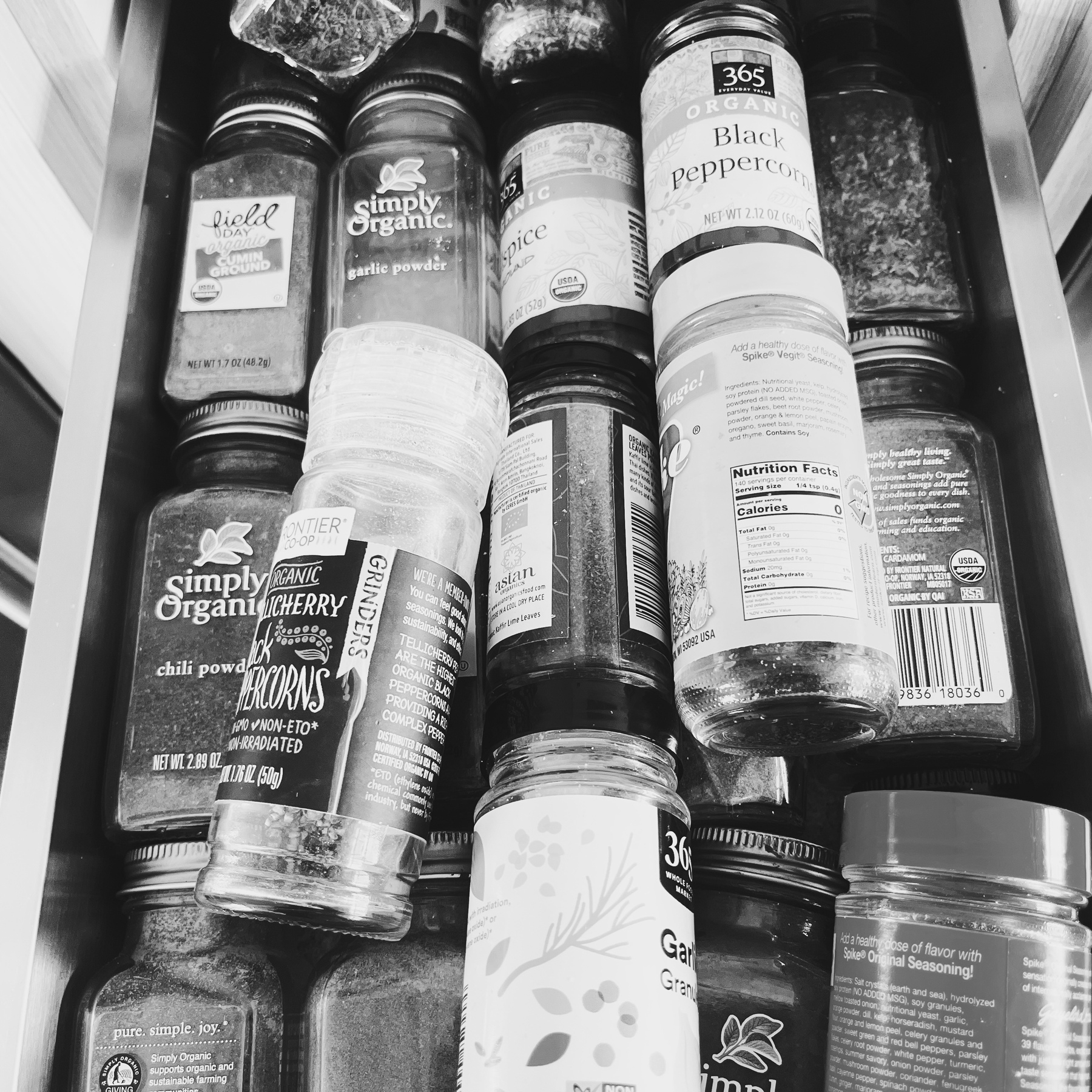 A black & white photo of a draw full of bottles of spices in our kitchen