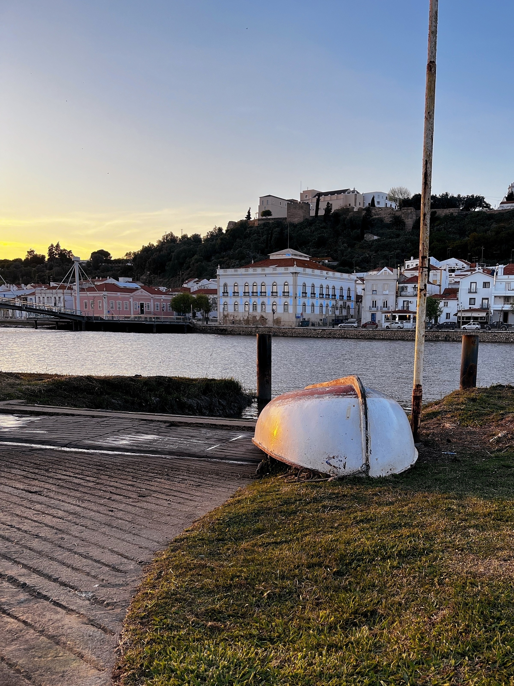 Evening light in Alcácer do Sal, setting sunlight reflected on the hill of an upturned rowing boat by the river