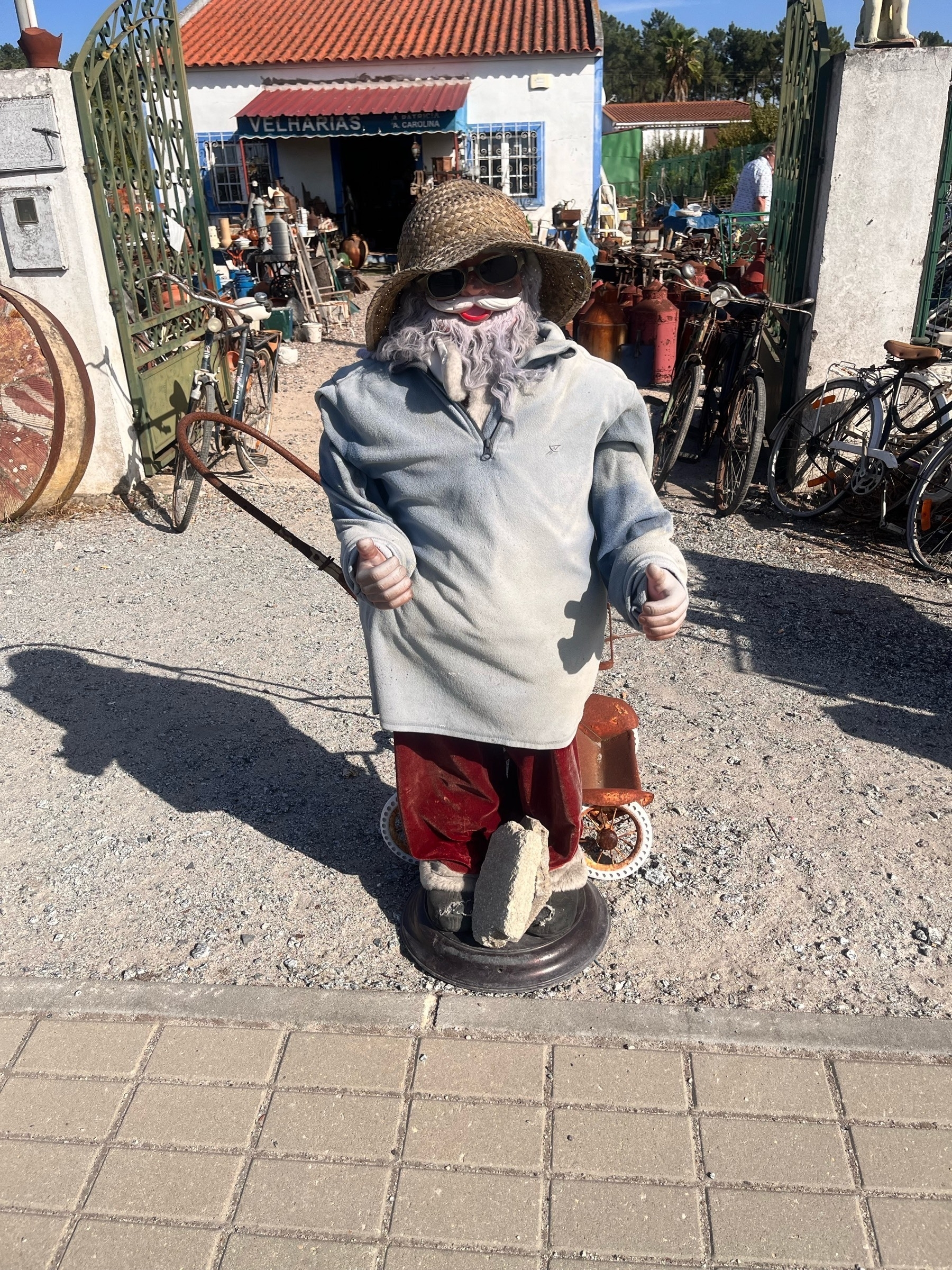 A mannequin of a fisherman, over dressed for the very hot weather