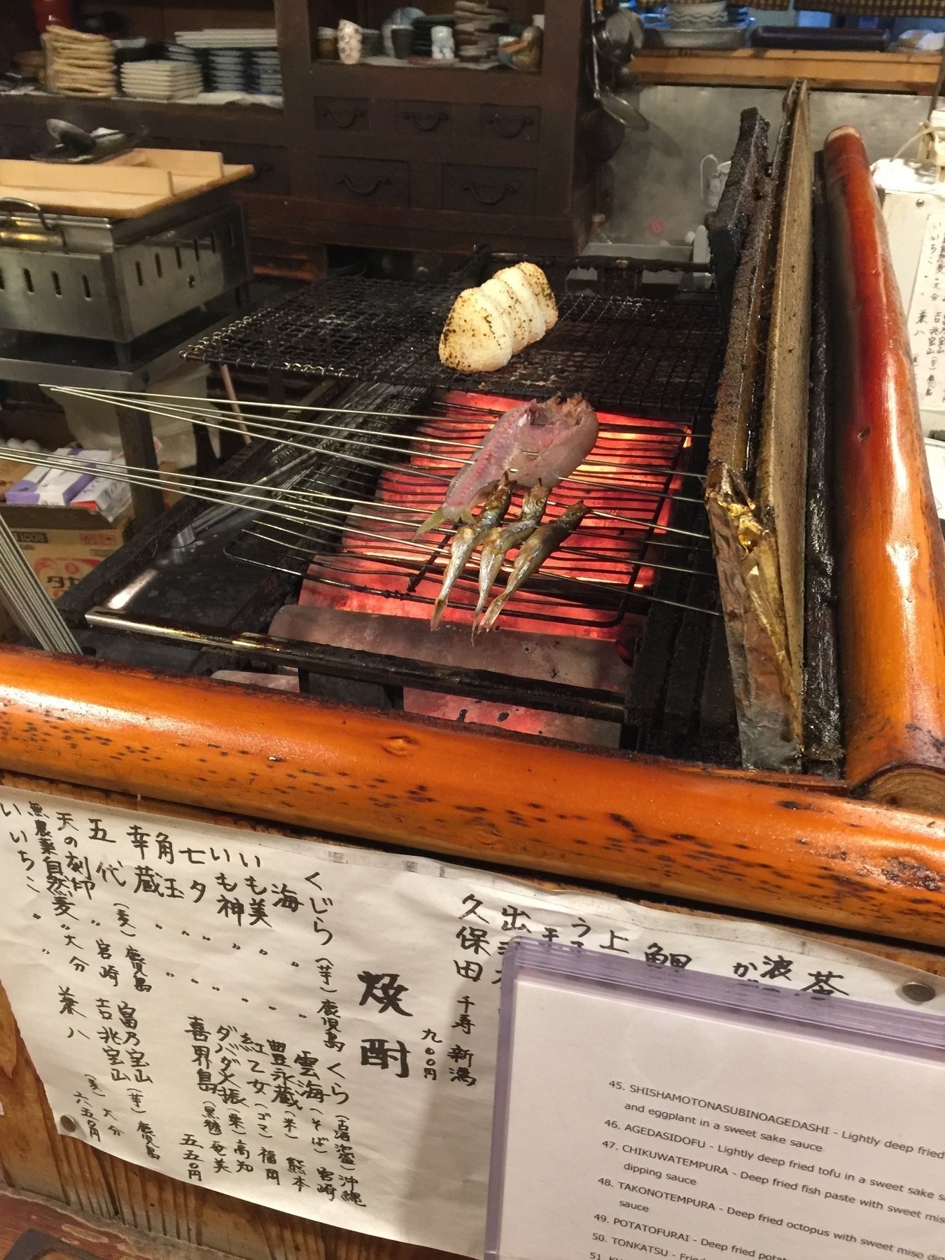 Grilling fish in a Japanese restaurant.